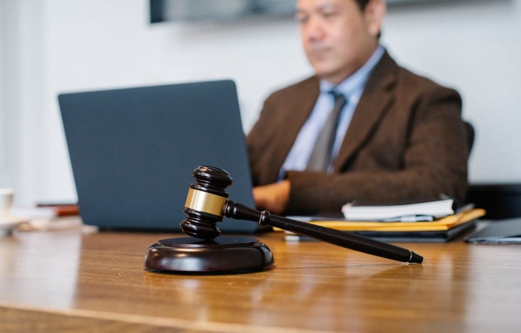 crop-asian-judge-working-on-laptop-in-office-5668772 Crop concentrated Asian male judge in formal clothes sitting using modern netbook while working in law office
